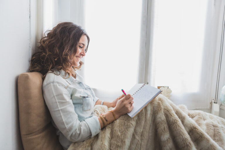 relaxed-young-woman-writing-her-notebook